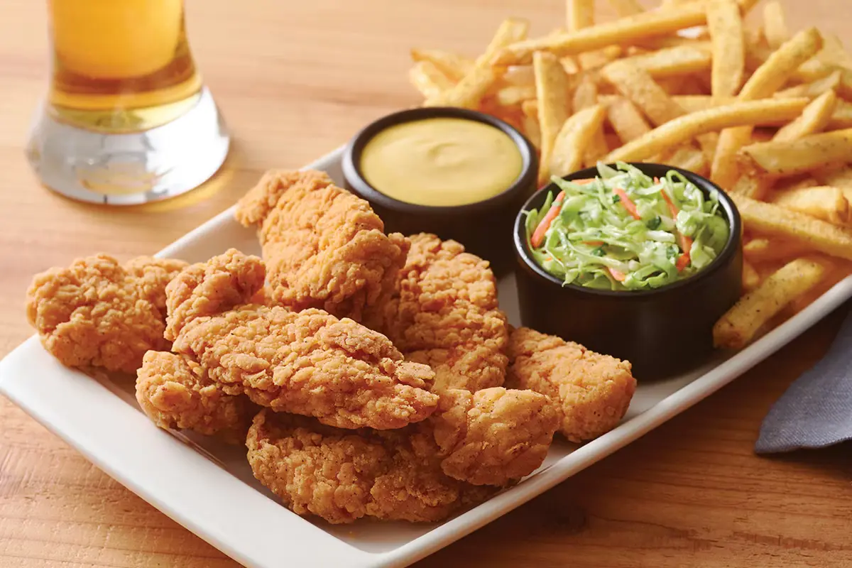 Golden fried chicken strips platter with sauces and side fries