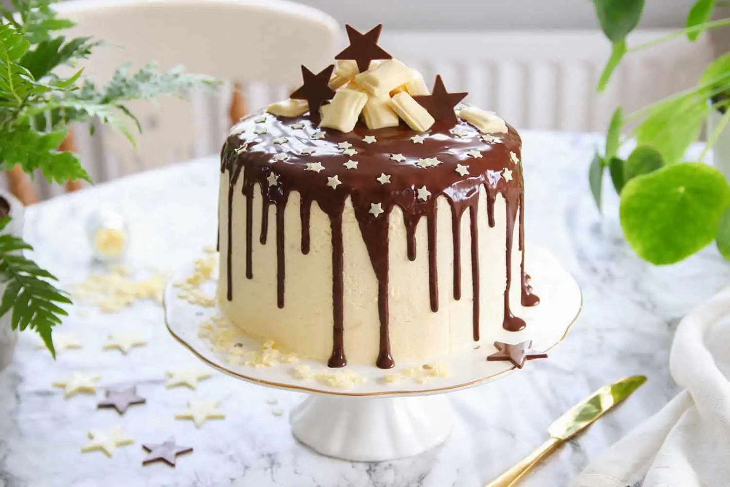 Chocolate drip cake topped with rich chocolate ganache and creamy frosting.