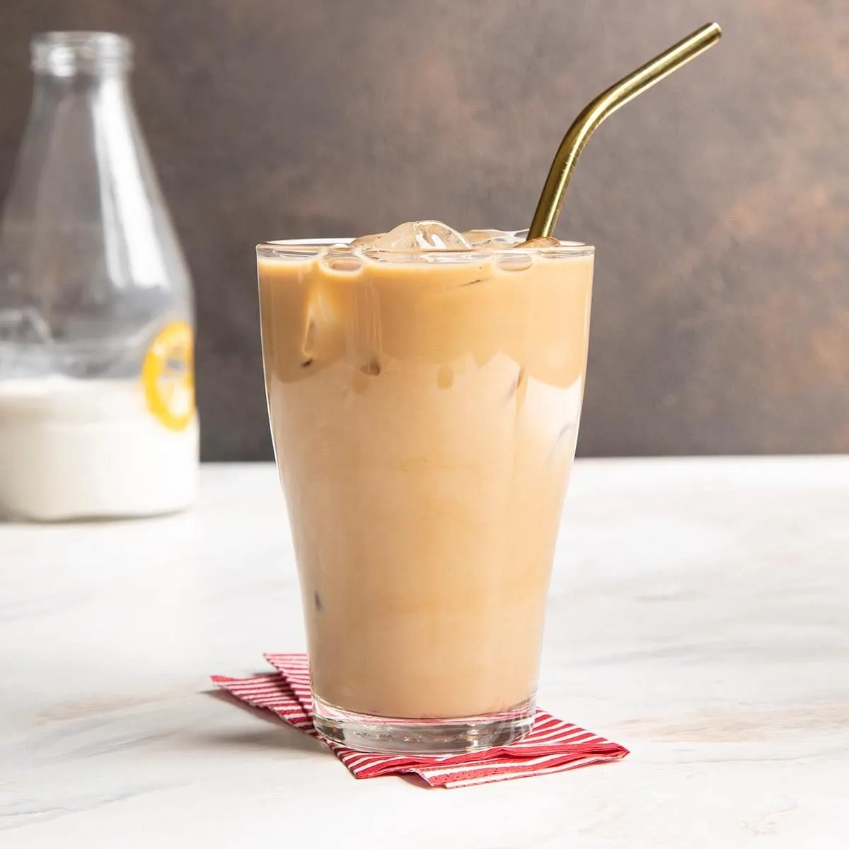 Cold coffee served with ice cubes and creamy froth