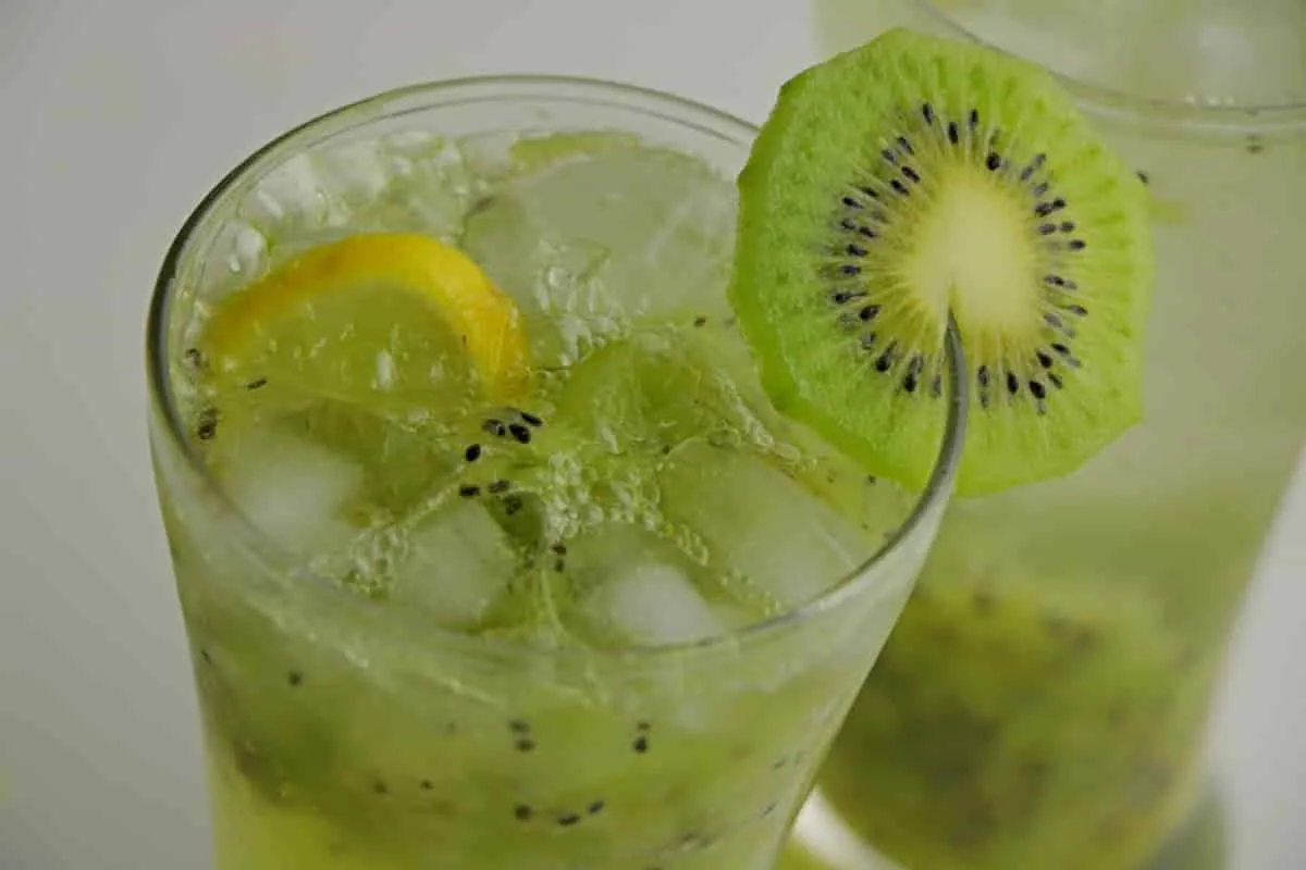 Green kiwi cooler drink served with ice and kiwi slices